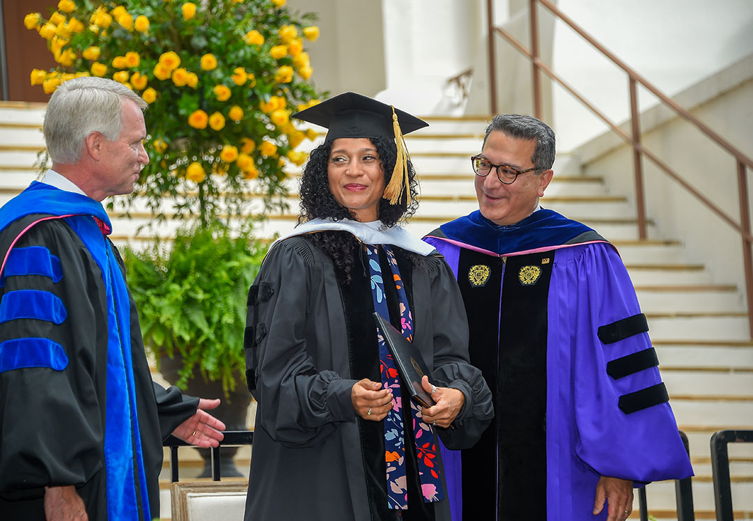 Dr. Philip Swicegood (left), Wofford’s R. Michael James Professor and chair of accounting, business and finance, stands alongside Alexandra Nunez (center), who received a Doctor of Finance, from Wofford’s President Nayef Samhat.