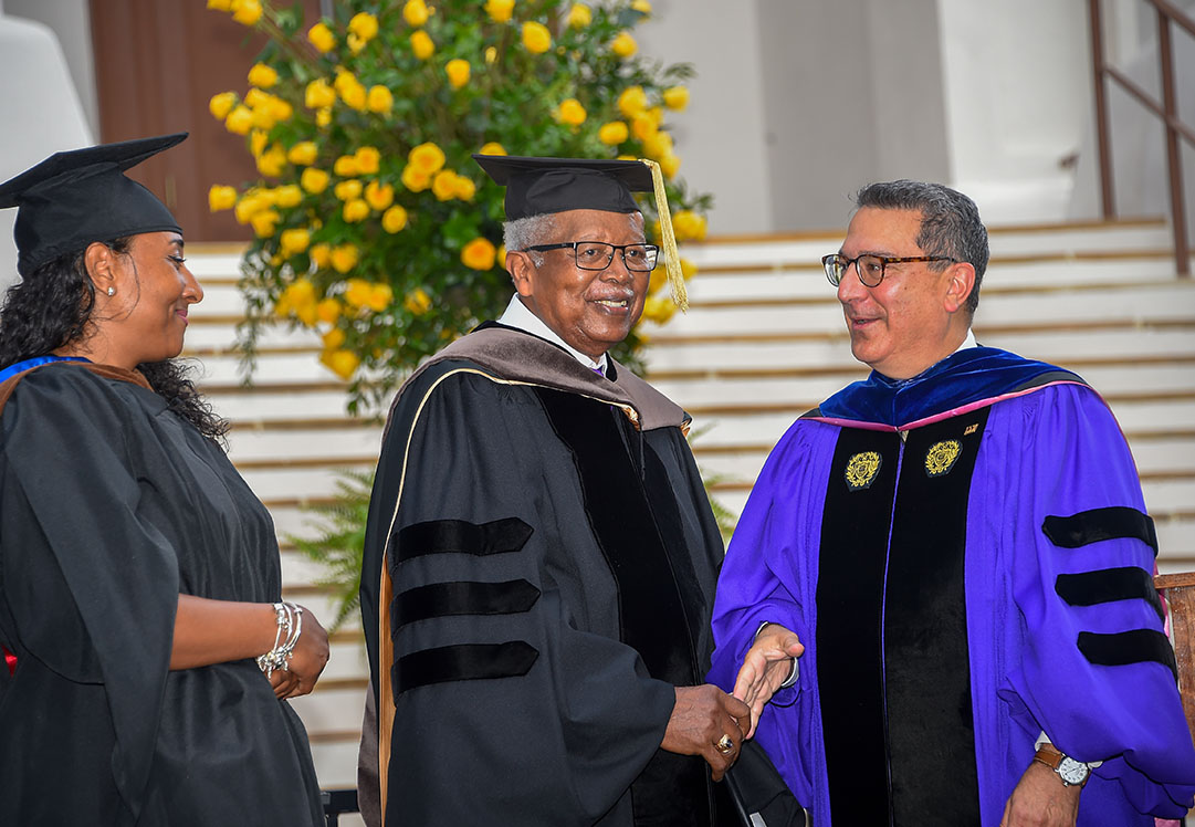Jessica Scott-Felder (left), a Wofford assistant professor of studio art, joins Dr. Leo Franklin Twiggs (center) as he receives a Doctor of Fine Arts from Wofford’s President Nayef Samhat.
